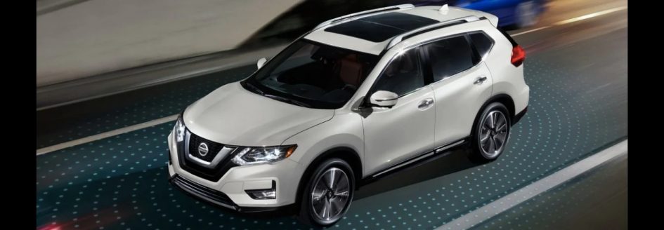 White 2019 Nissan Rogue driving with Nissan Intelligent Mobility lights around it