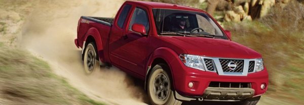 Red 2019 Nissan Frontier on dirt path